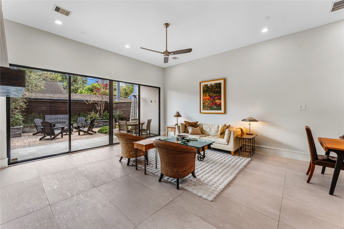 917 Peden Street Houston, TX 77006 - Photo 11 of 50 This spacious living area is designed for both relaxation and entertaining, with clean lines and modern finishes throughout. The open flow connects seamlessly to the kitchen and dining areas, enhancing functionality. Whole-home upgrades, including a Generac 24KW standby generator, ensure uninterrupted comfort.
