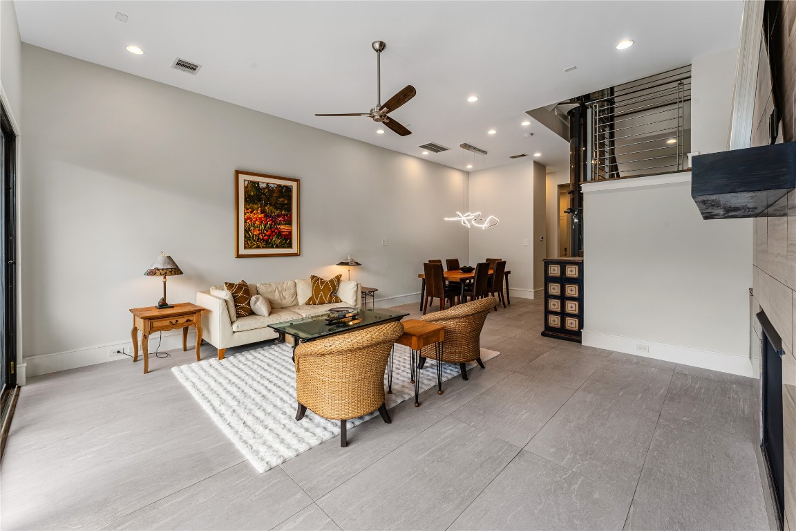 917 Peden Street Houston, TX 77006 - Photo 12 of 50 An inviting open-concept living and dining area designed for both comfort and connection. Clean architectural lines and modern finishes create a bright, airy atmosphere. The layout offers flexibility for both casual living and formal entertaining.