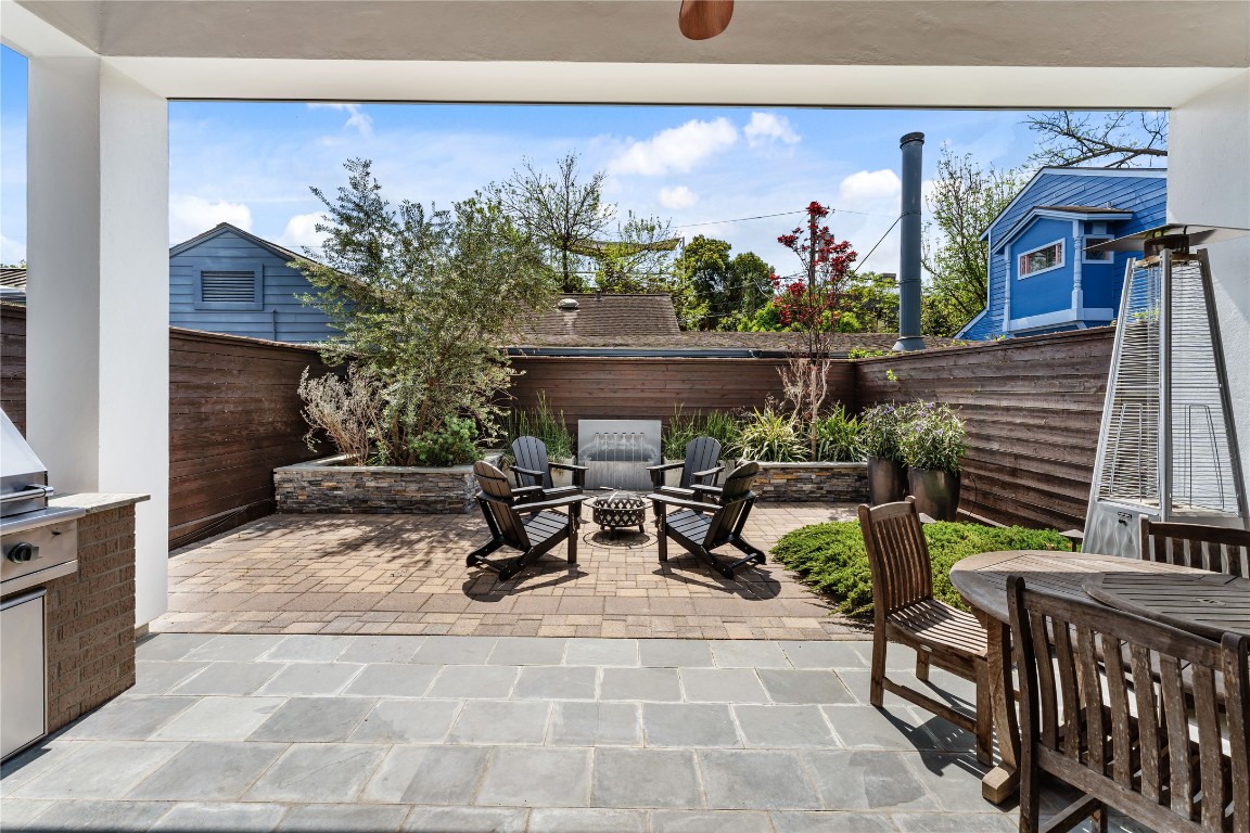 917 Peden Street Houston, TX 77006 - Photo 16 of 50 A private backyard retreat ideal for evening gatherings. Lush landscaping and raised planters with sprinkler system create a serene, resort-style atmosphere. This thoughtfully designed outdoor space offers both comfort and privacy.