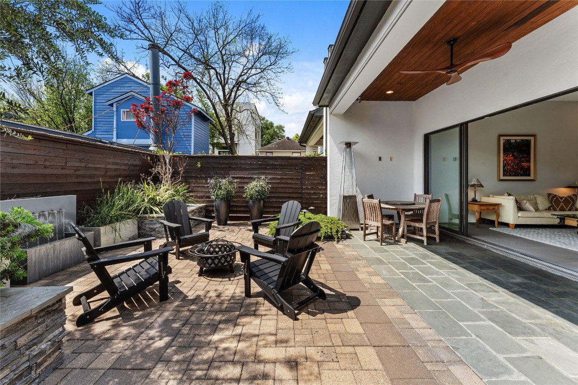 917 Peden Street Houston, TX 77006 - Photo 17 of 50 A private outdoor retreat featuring several seating areas and professionally landscaped surroundings and sprinkler system. The outdoor kitchen includes a Viking Professional 5 Series grill, perfect for hosting gatherings. Thoughtfully designed for both relaxation and entertaining, this space offers a true extension of the home.
