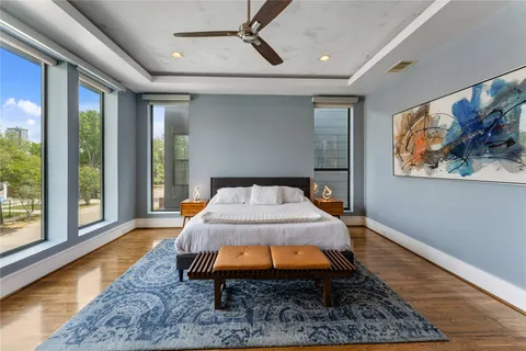 a bedroom with bed and a chandelier