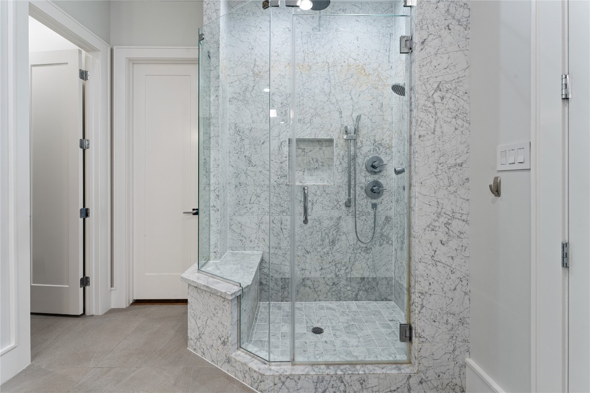 917 Peden Street Houston, TX 77006 - Photo 27 of 50 An impressive marble-clad walk-in shower with frameless glass enclosure and designer fixtures. Clean lines and high-end materials create a true spa-like experience. This luxurious feature highlights the home’s attention to detail and craftsmanship.