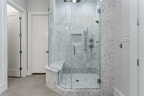 a bathroom with a double vanity sink mirror and shower
