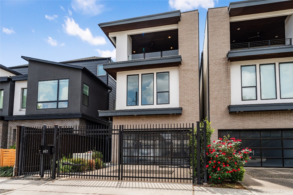 917 Peden Street Houston, TX 77006 - Photo 2 of 50 Striking modern elevation with clean architectural lines, enhanced by a private driveway gate and sidewalk entry gate for added security and exclusivity. This luxury residence is thoughtfully designed by one of Houston’s premier builders, offering both style and functionality. Professionally landscaped grounds and a camera video alarm system provide both beauty and peace of mind.