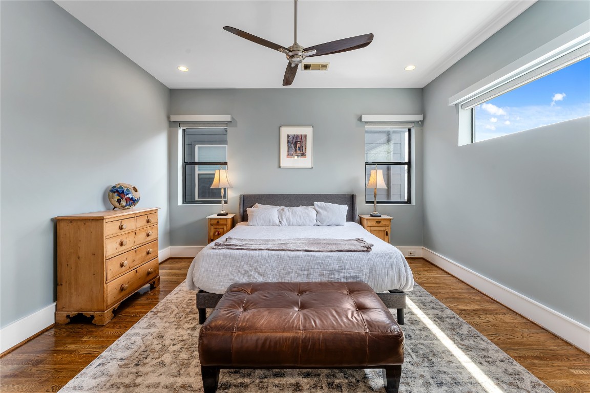 917 Peden Street Houston, TX 77006 - Photo 32 of 50 A light-filled bedroom featuring large windows, clean lines, and warm wood flooring. Neutral tones and modern finishes create a calm, inviting atmosphere. This space is ideal for guests, family, or a private retreat.