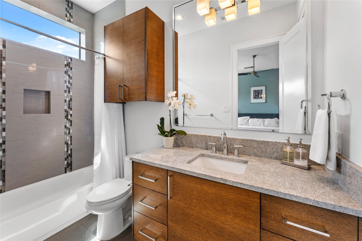 917 Peden Street Houston, TX 77006 - Photo 33 of 50 A beautifully finished bathroom featuring sleek countertops, modern fixtures, and custom cabinetry. Designer tilework and clean lines create a polished, contemporary feel. Every detail reflects the home’s commitment to quality and elevated design.