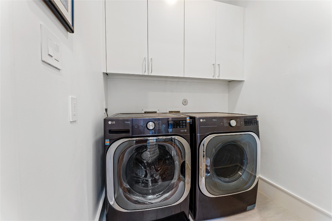 917 Peden Street Houston, TX 77006 - Photo 34 of 50 A well-appointed laundry room featuring with sleek cabinetry providing ample storage. Clean lines and functional design make everyday tasks effortless. This space combines practicality with the home’s overall elevated aesthetic.