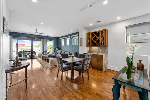 a dining room with furniture a window and wooden floor