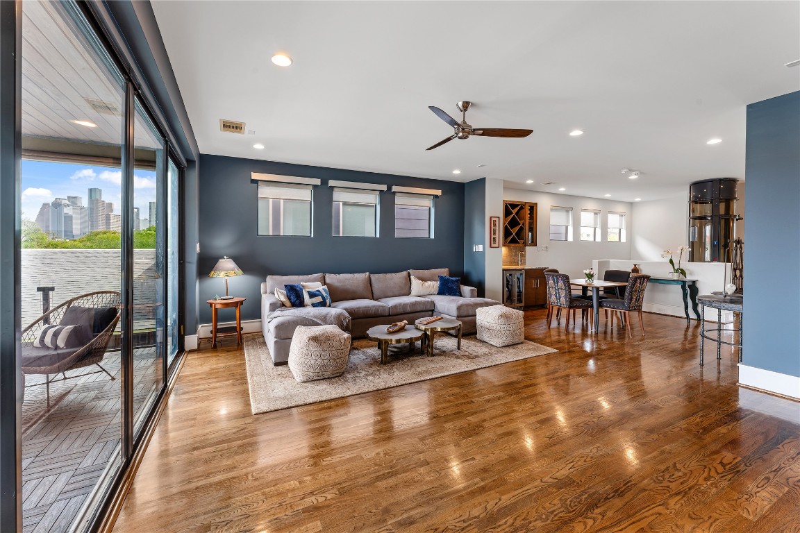 917 Peden Street Houston, TX 77006 - Photo 38 of 50 This impressive living space showcases seamless flow between indoor living and outdoor entertaining areas. Expansive glass doors open to a covered balcony, extending the living area outward. Clean lines and premium finishes highlight the home’s contemporary design.