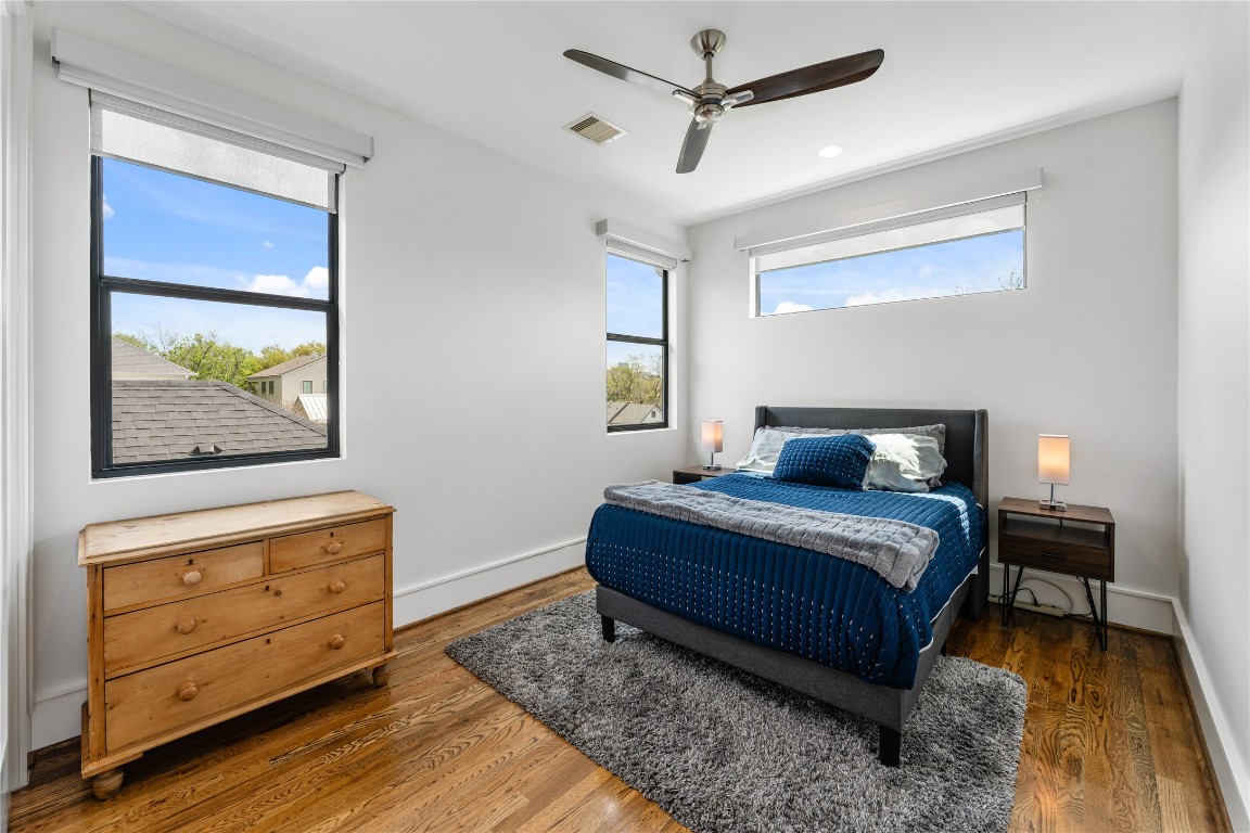 917 Peden Street Houston, TX 77006 - Photo 46 of 50 A light-filled bedroom featuring large windows, clean lines, and warm wood flooring. Neutral tones and modern finishes create a calm, inviting atmosphere. This space is ideal for guests, family, or a private retreat.