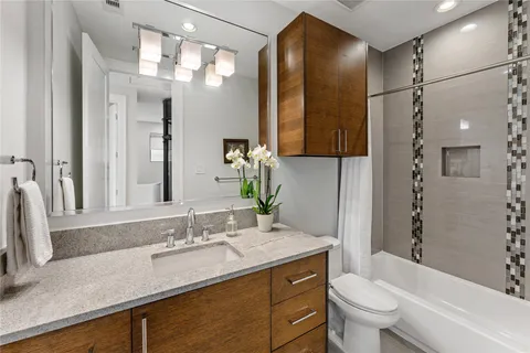 a picture of a bathroom with mirror and sink