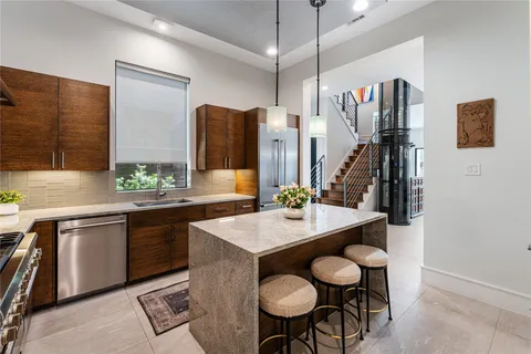 a kitchen with sink cabinets and stainless steel appliances