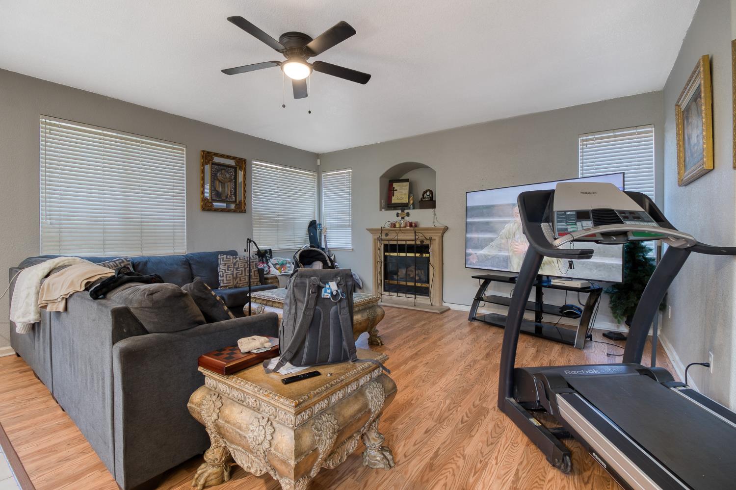 6282 Crestview Circle Stockton, CA 95219 - Photo 12 of 22 a living room with furniture a clock on wall and a window