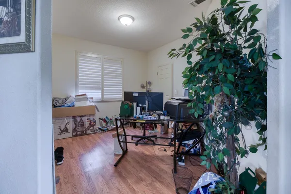 a workspace room with furniture and wooden floor