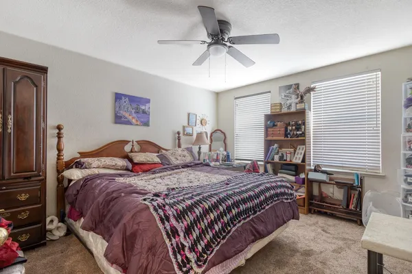 a bedroom with bed and a window