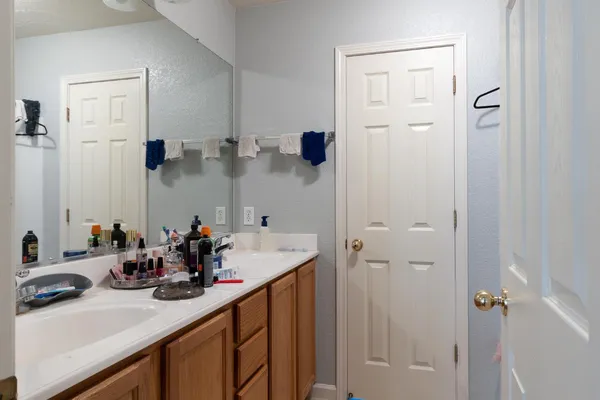 a bathroom with a sink double vanity and a mirror