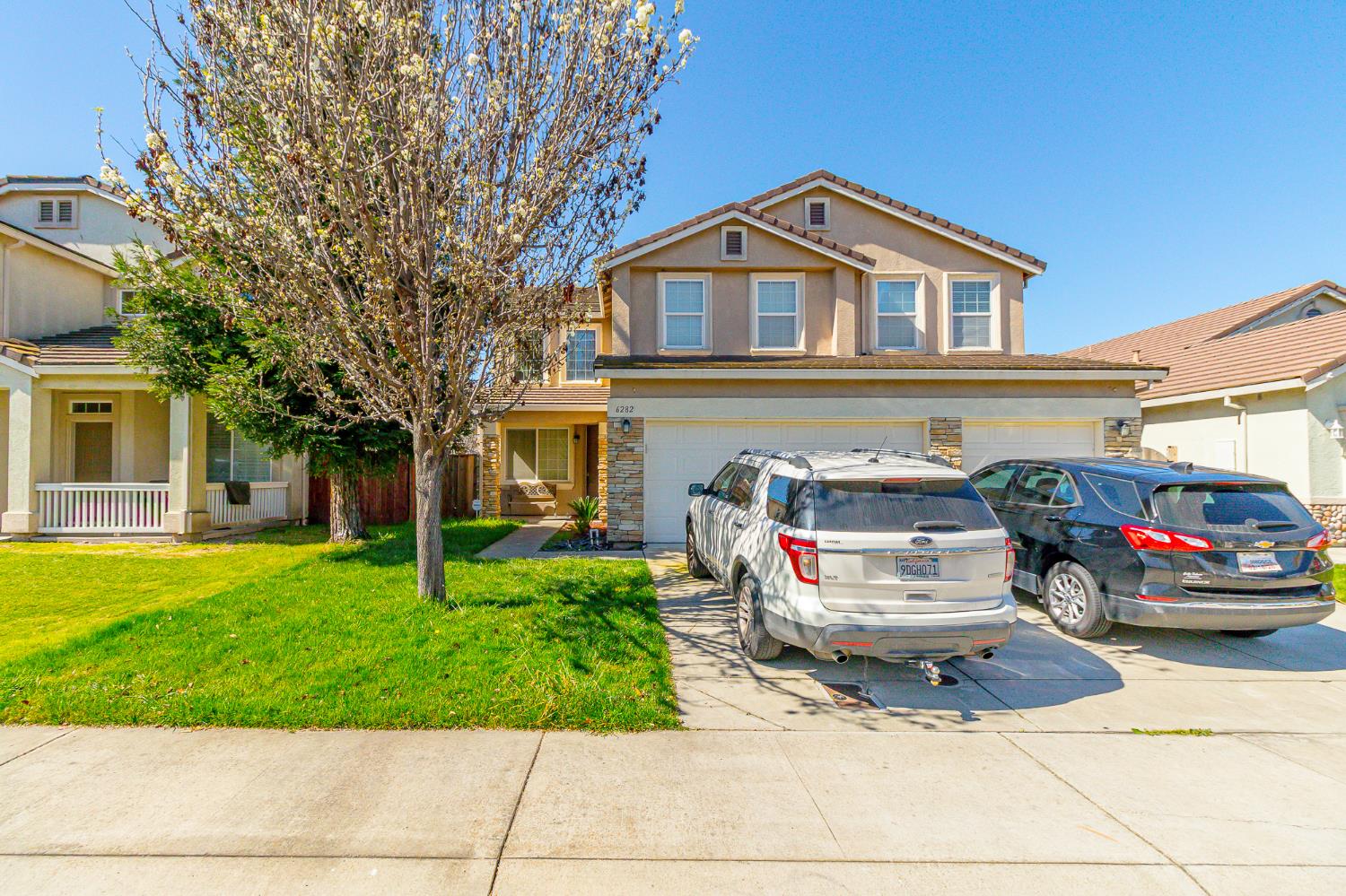 6282 Crestview Circle Stockton, CA 95219 - Photo 2 of 22 a front view of a house with a garden and trees