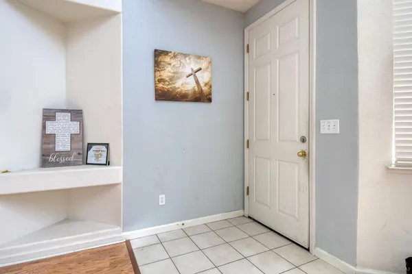a view of an empty room with window and cabinet