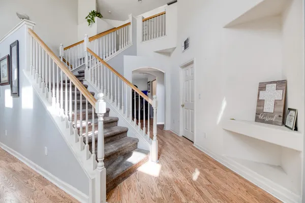 a view of entryway and hall with wooden floor