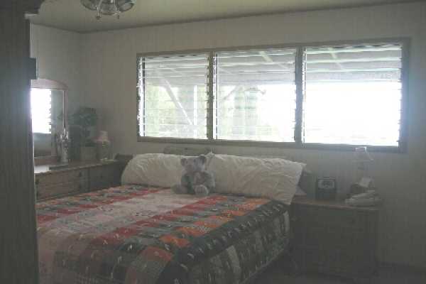 82-1052 Kinue Road Captain Cook, HI 96704 - Photo 7 of 9 a bedroom with a bed and a window
