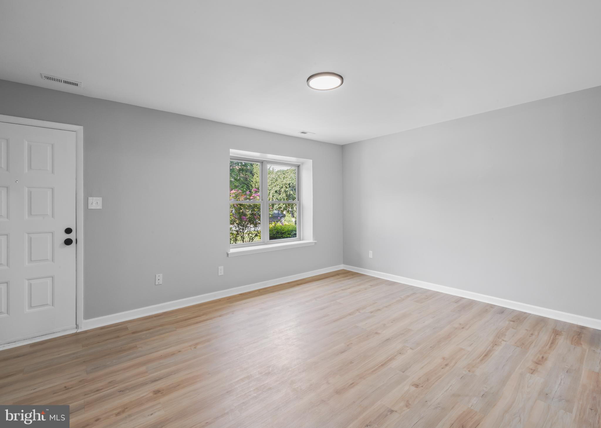 6 Heron Place Clementon, NJ 08021 - Photo 11 of 29 a view of an empty room with wooden floor and a window