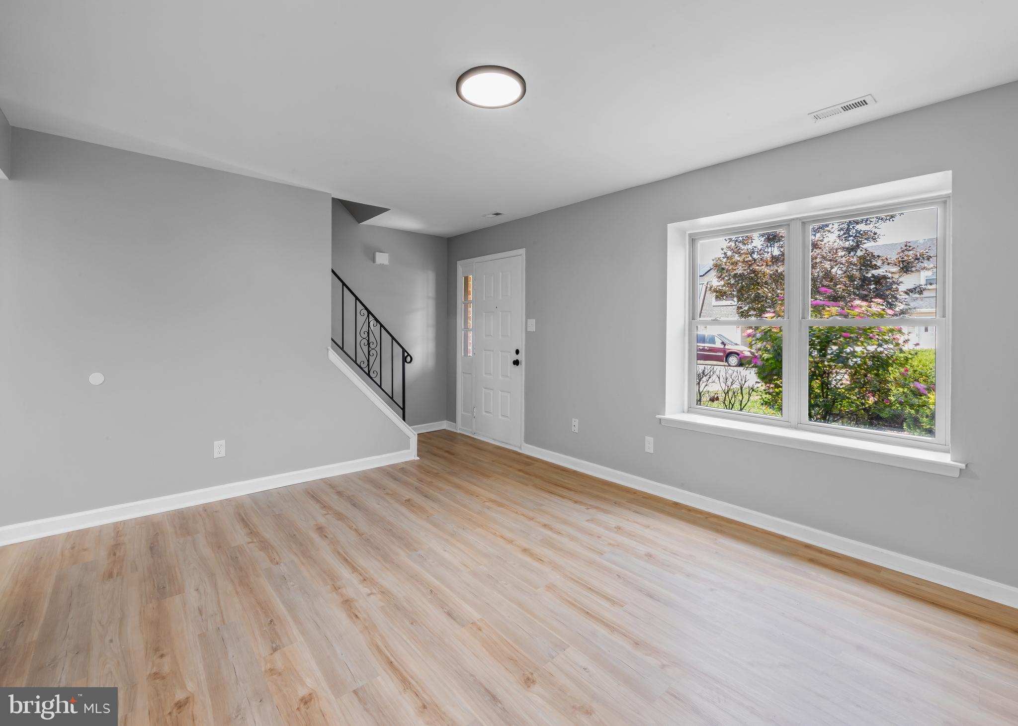 6 Heron Place Clementon, NJ 08021 - Photo 12 of 29 a view of an empty room with wooden floor and a window