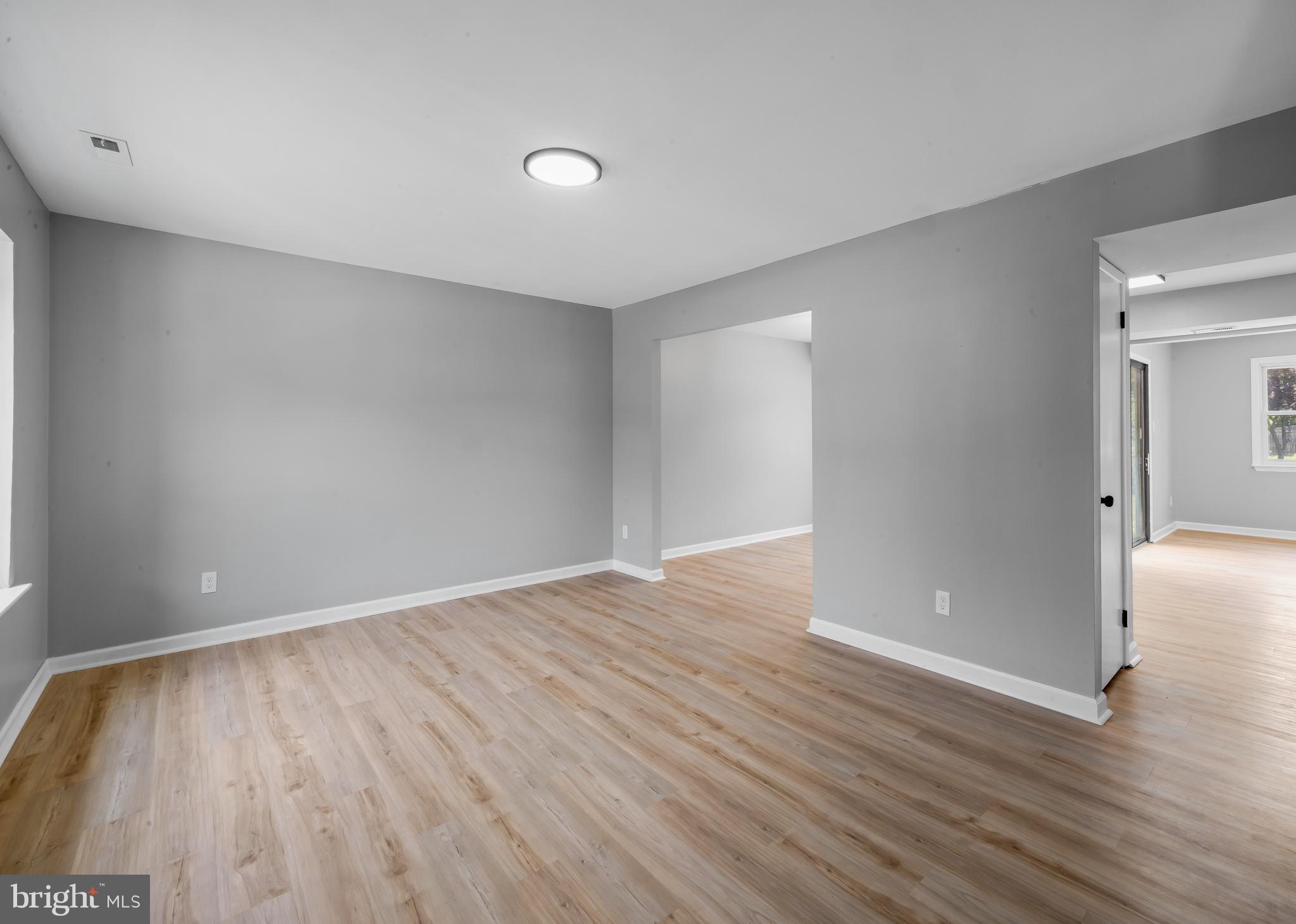 6 Heron Place Clementon, NJ 08021 - Photo 14 of 29 a view of an empty room with wooden floor and a window