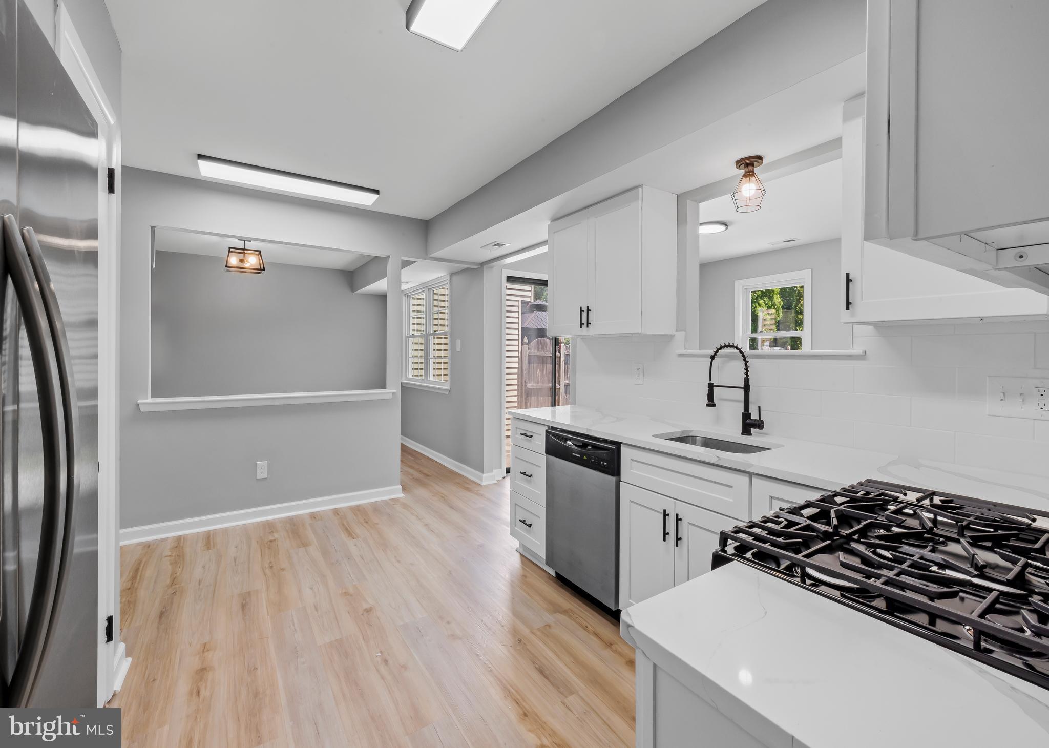 6 Heron Place Clementon, NJ 08021 - Photo 6 of 29 a kitchen with granite countertop a refrigerator and a stove top oven
