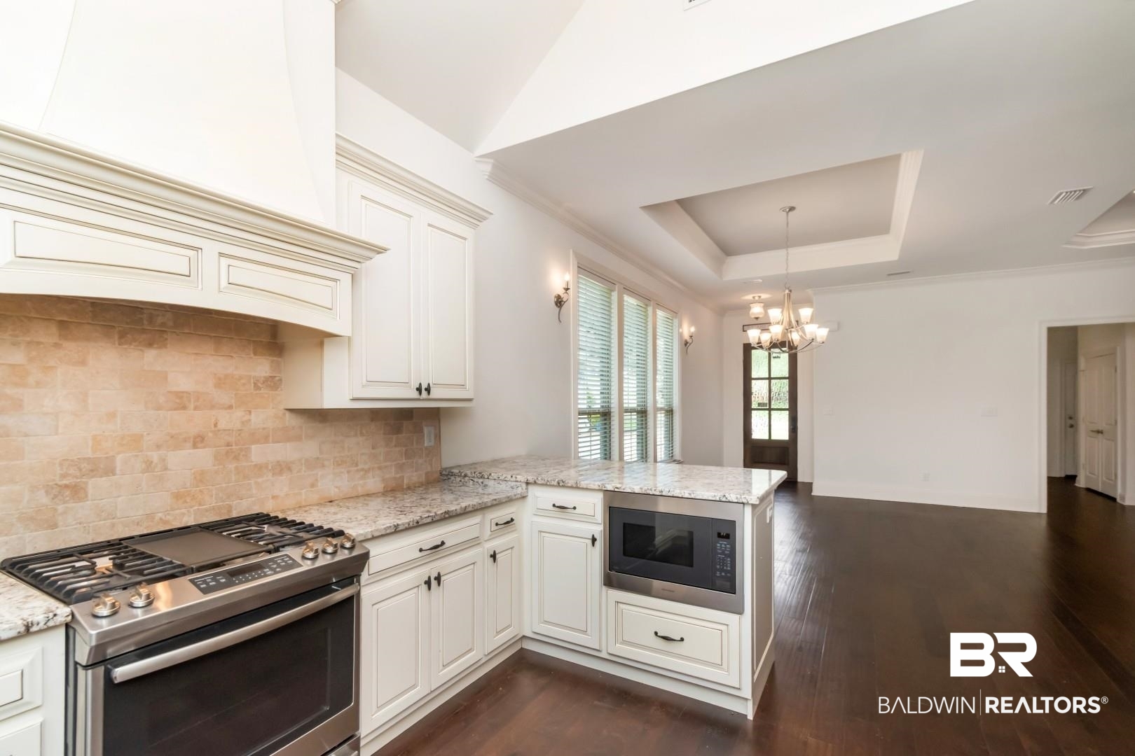 3528 Rue Royal Mobile, AL 36693 - Photo 15 of 53 Well-appointed kitchen featuring white cabinetry, stone countertops, a stainless steel range, and a built-in microwave