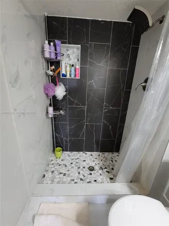 a bathroom with a toilet and shower
