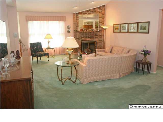 51 Lexington Road Freehold, NJ 07728 - Photo 3 of 3 a living room with furniture and a fireplace
