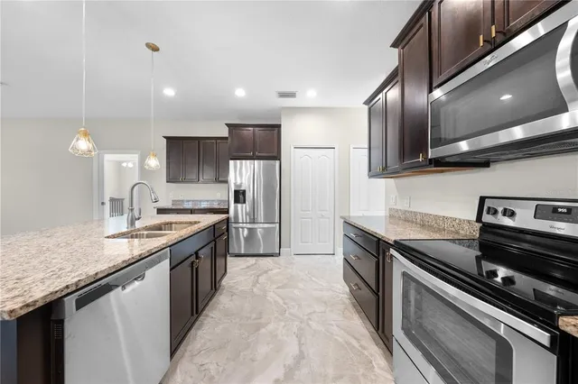 a utility room with sink dryer and washer