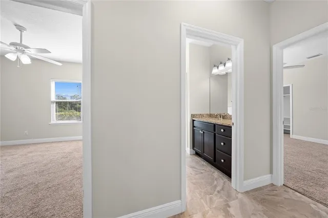 an empty room with closet and ceiling fan