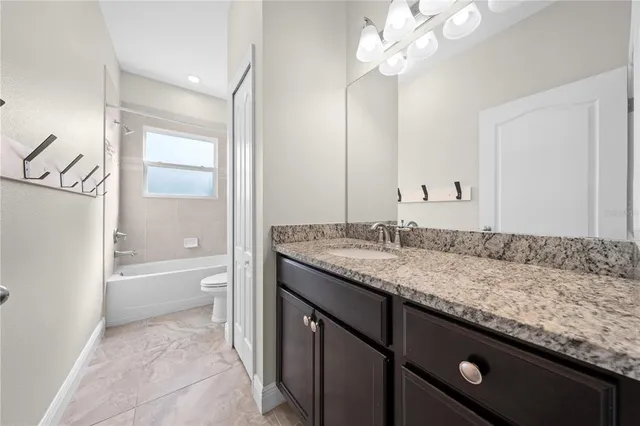 an empty room with closet and fan