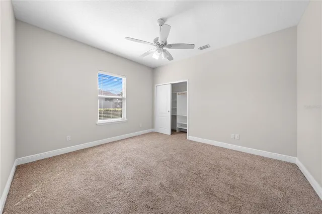 a spacious bathroom with a granite countertop sink a light fixture and a mirror