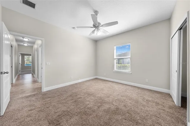 a bathroom with a double vanity sink a toilet and a mirror