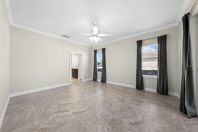a view of a livingroom with a ceiling fan and window
