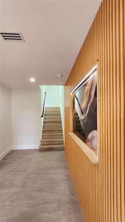 7609 Deedra Circle Port Richey, FL 34668 - Photo 17 of 63 a view of a hallway with wooden floor and white walls