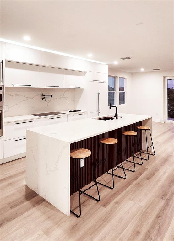 7609 Deedra Circle Port Richey, FL 34668 - Photo 22 of 63 a kitchen with a sink cabinets and wooden floor