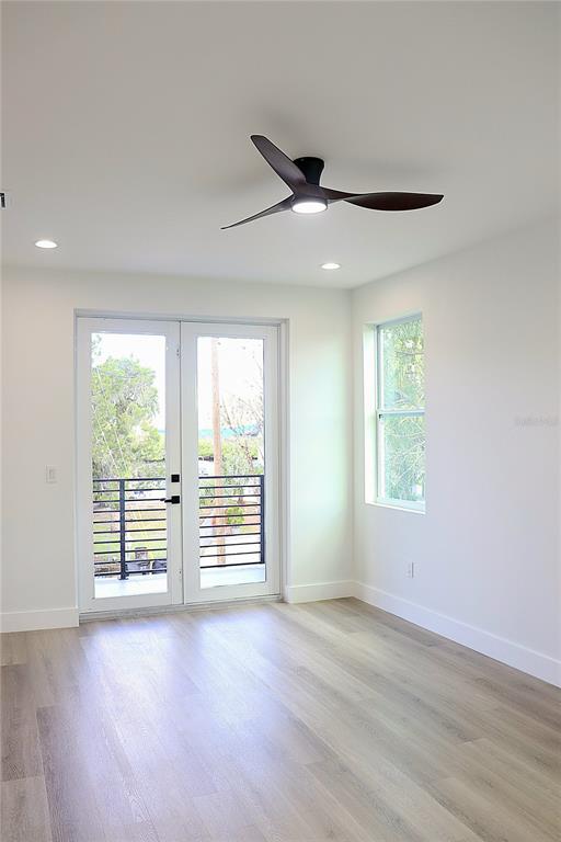 7609 Deedra Circle Port Richey, FL 34668 - Photo 30 of 63 an empty room with wooden floor and windows