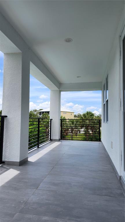 7609 Deedra Circle Port Richey, FL 34668 - Photo 32 of 63 a view of an empty room with a floor to ceiling window and wooden floor