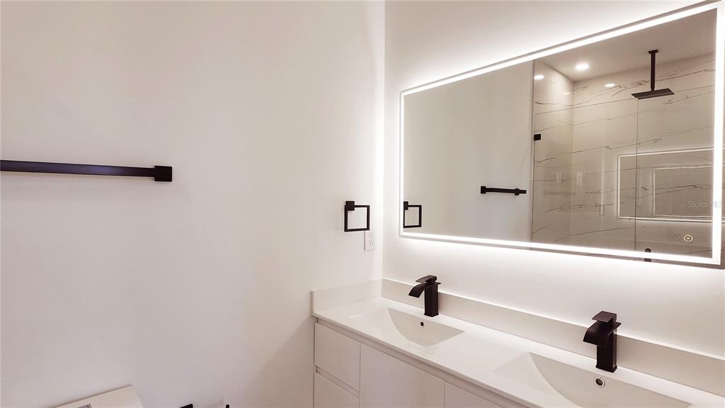 7609 Deedra Circle Port Richey, FL 34668 - Photo 36 of 63 a bathroom with a sink and a mirror