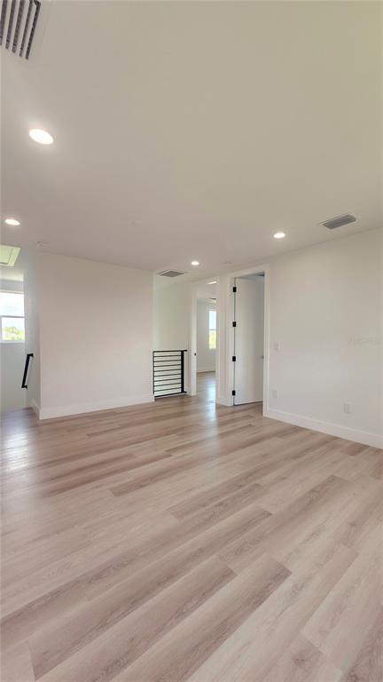 7609 Deedra Circle Port Richey, FL 34668 - Photo 39 of 63 a view of empty room with wooden floor