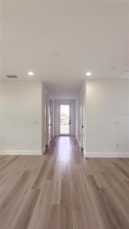 7609 Deedra Circle Port Richey, FL 34668 - Photo 40 of 63 a view of an empty room with wooden floor and window