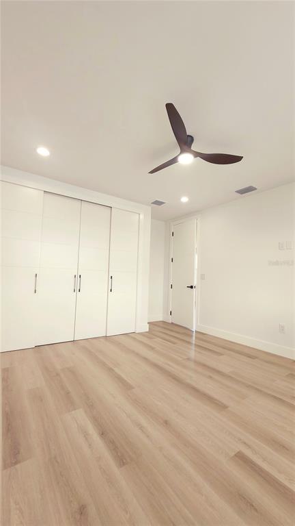 7609 Deedra Circle Port Richey, FL 34668 - Photo 42 of 63 a view of an empty room with a ceiling fan