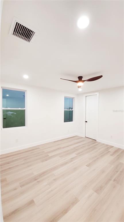 7609 Deedra Circle Port Richey, FL 34668 - Photo 44 of 63 a view of a livingroom with wooden floor and a ceiling fan
