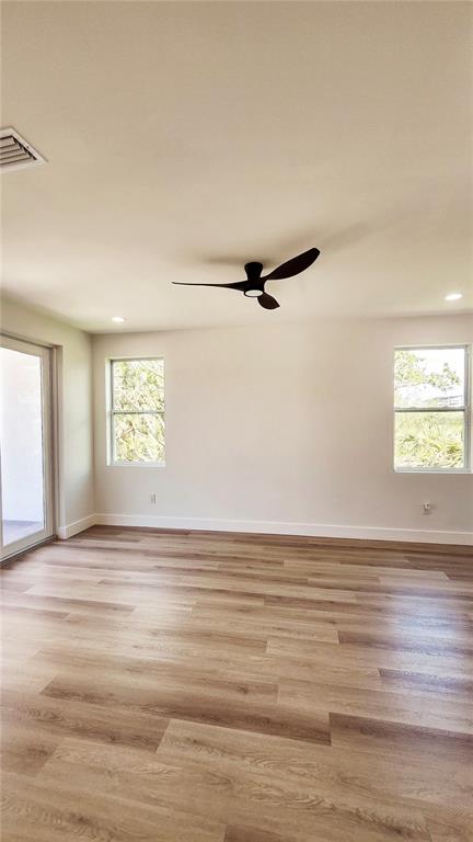 7609 Deedra Circle Port Richey, FL 34668 - Photo 50 of 63 a view of an empty room with window and wooden floor