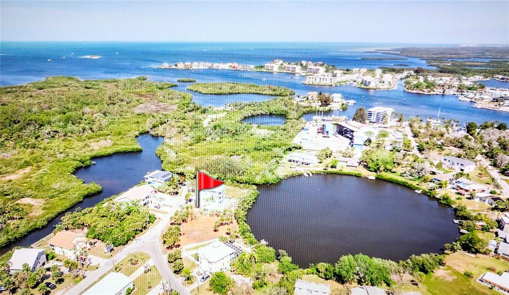 7609 Deedra Circle Port Richey, FL 34668 - Photo 54 of 63 a view of a lake with a building in the background
