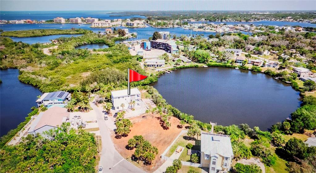 7609 Deedra Circle Port Richey, FL 34668 - Photo 58 of 63 an aerial view of a houses with a lake view