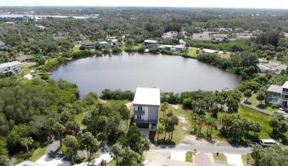 7609 Deedra Circle Port Richey, FL 34668 - Photo 6 of 63 an aerial view of house with yard and lake view